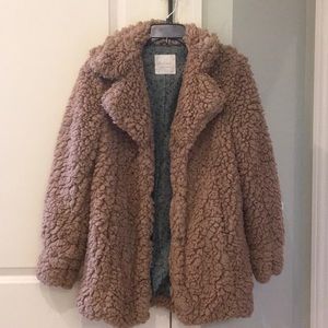Tan furry coat.